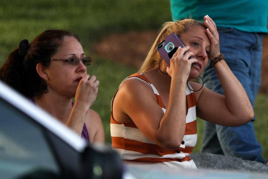 Family members and friends wait for their loved ones after the shooting.