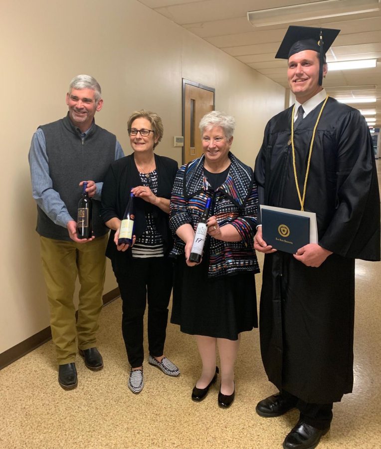 (Left to right) Kent State enology instructor Ed Trebets holds a homemade wine bottle alongside Laurello Vineyards owner Kim Laurello, Kent State Ashtabula Dean Susan Stocker, and Kent State graduate Brad Indoe.