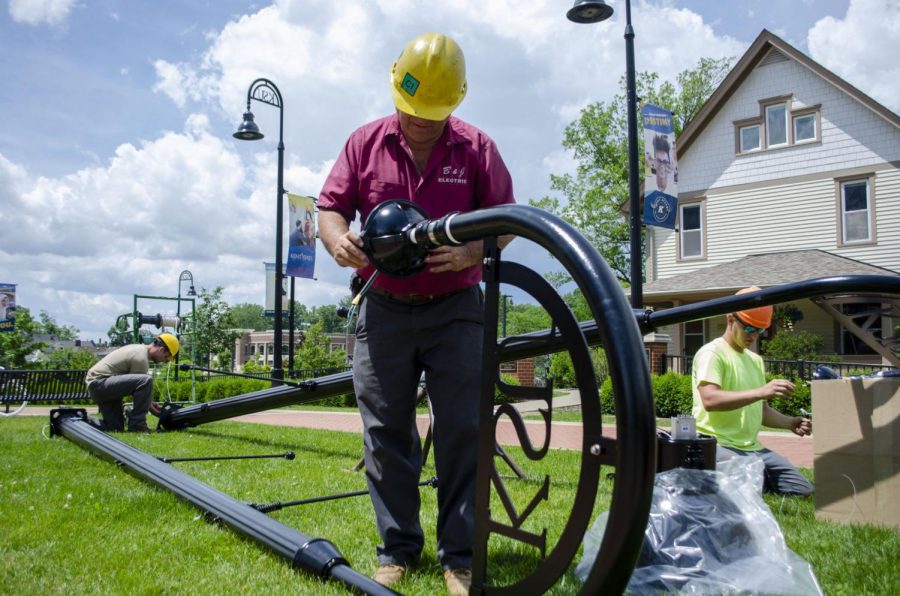 Nick Ramsey (left), Fred Lyda (center) and Gene Mock (right) all work on the new KSU lamps that will light the South Lincoln Street crosswalk by the Architecture Building.