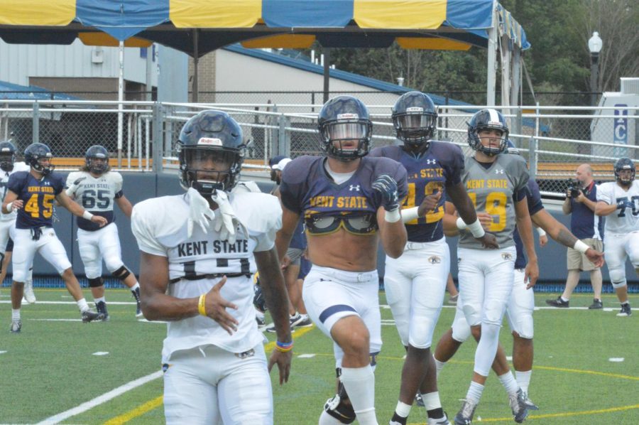 Several Kent State players warming up before the start of the fall scrimmage before that start of the season on Aug. 19 2019. 