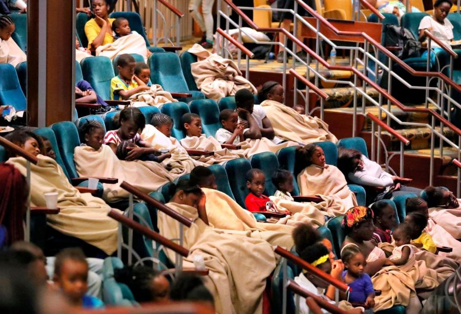 Evacuees from Freeport, Bahamas, rest onboard the Royal Caribbean's Mariner of the Seas cruise ship after it arrived in Freeport, Saturday, Sept. 7, 2019.