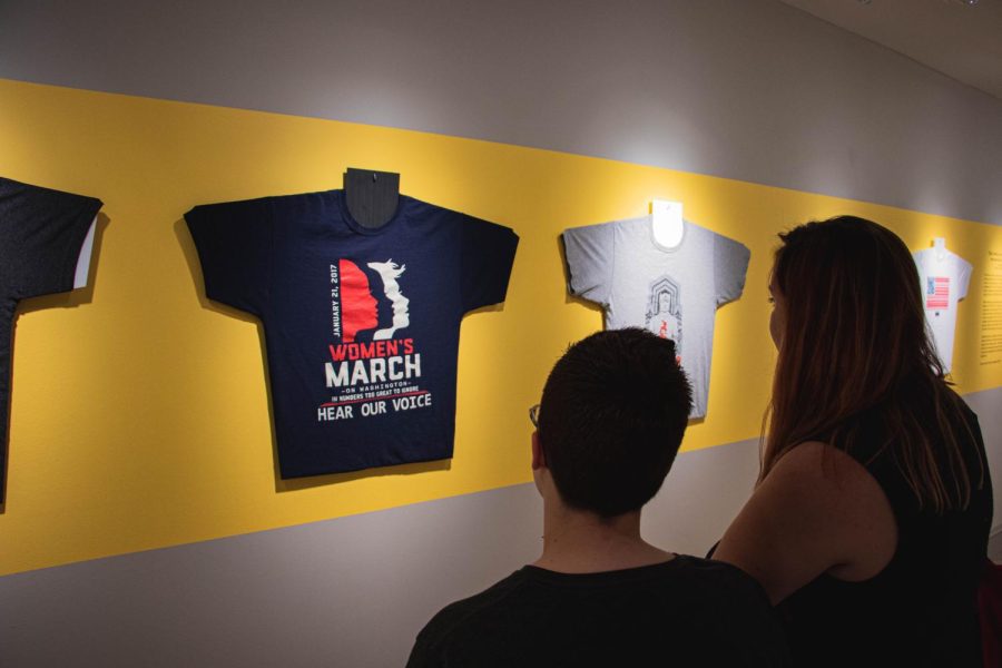 Moira Armstrong an English and History major(Left) and Jordan George a Fashion major (Right) admire the "Wearing Justice" exhibit at the Kent State University Museum. This Exhibit shows the use of Graphic T-Shirts during heated political moments and showcases their meanings. Sep 13, 2019.