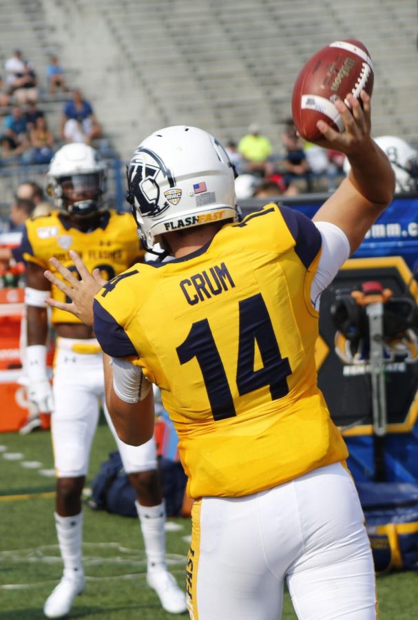 Quarterback Dustin Crum passes with wide receiver Javaughn Williams before the Homecoming game on Sept. 21. 