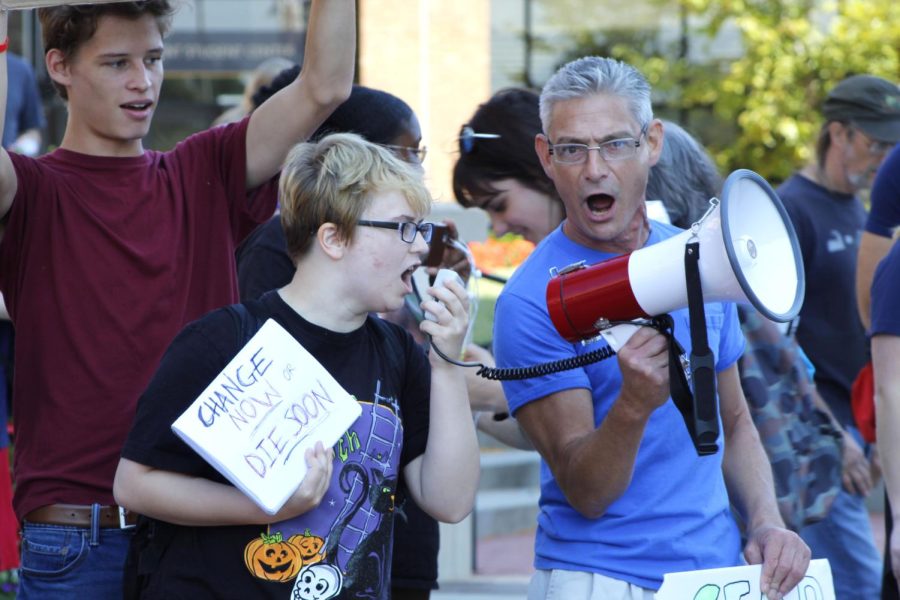 Protestors shout chants through the megaphone at the Kent Climate Strike on Sept. 20 on Risman Plaza. Chants includes phrases such as "Hey hey, ho ho. Oil Lobbies got to go."