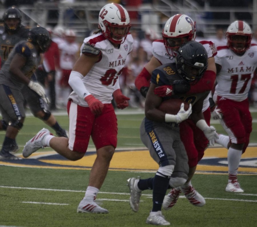 Redshirt sophomore running back Xavier Williams gets run down by Miami defenders during first half on Oct. 26, 2019. The Golden Flashes lost 16-23 against Miami Ohio.