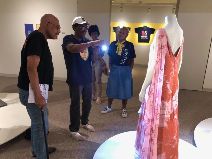 Silas Ashley takes a photo of the dress associate professor Dr. Tameka Ellington created. Ellington created the dress from a 1972 photo of Ashley protesting the Vietnam War. 