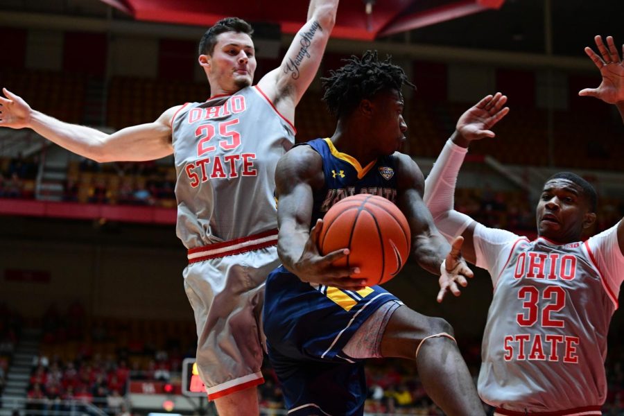 Antonio Williams (with ball) passes around Kyle Young (25) and E.J. Liddell (32). Williams finished with two assists and four turnovers in Kent State's 71-52 loss at Ohio State on Nov. 25. 