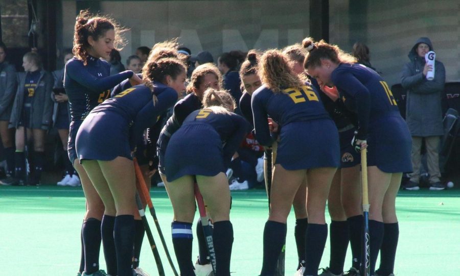 The field hockey team gathers in a huddle. Courtesy of Kent State athletics. 