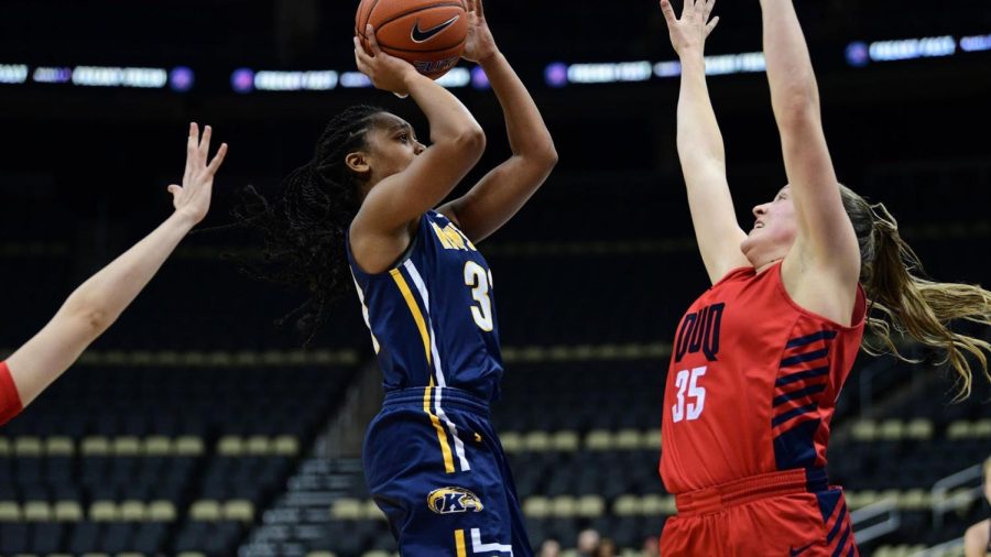 Megan Carter (left) goes up for a shot while Amanda Kalin (right) attempts to block her at the season opener on Nov. 5, 2019. 