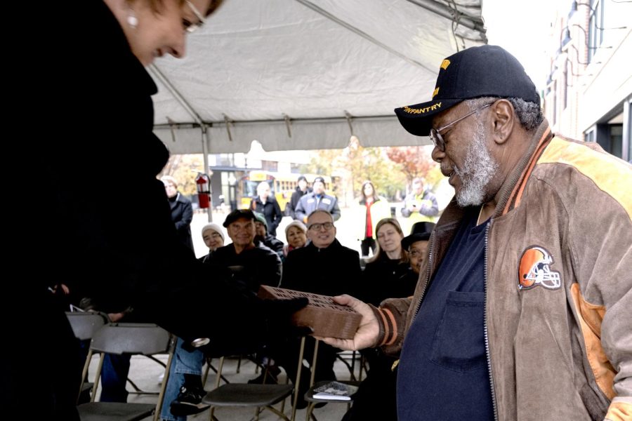 Claudia Amrhein, PARTA General Manager, presents veteran Walter Williams a brick inscribed with his name and time served during Kent's Veterans Day Ceremony in downtown Kent on Monday, Nov. 11, 2019. Williams served continuously from 1975-1986 in the United States, Korea and Germany.