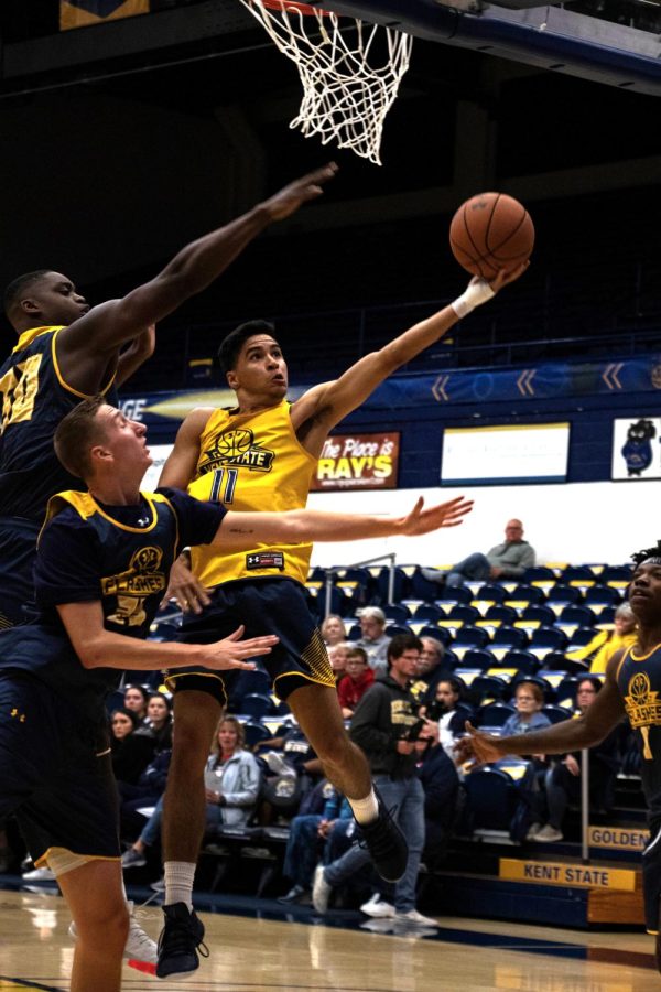 KSU gold team's Giovanni Santiago does a layup while Evab Bainbridge and Kalin Bennett try to block him at the scrimmage on Nov. 2, 2019 in the MACC.