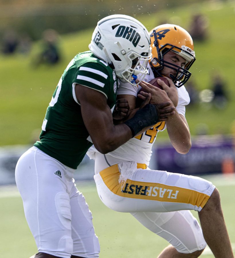 Junior quarterback Dustin Crum is tackled after running the ball during Kent State's game at Ohio University on Saturday, Oct. 19, 2019.