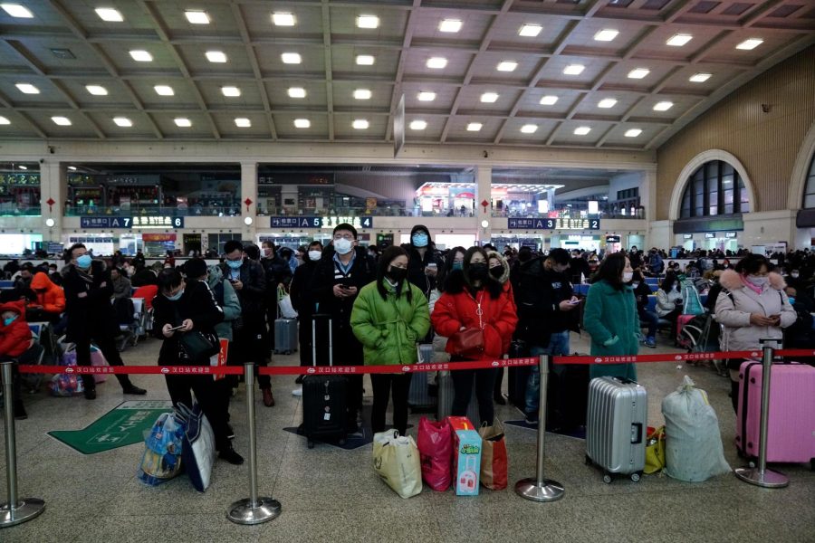 Travelers at Wuhan's Hankou railway station queue to leave the city before the citywide lockdown came into effect.