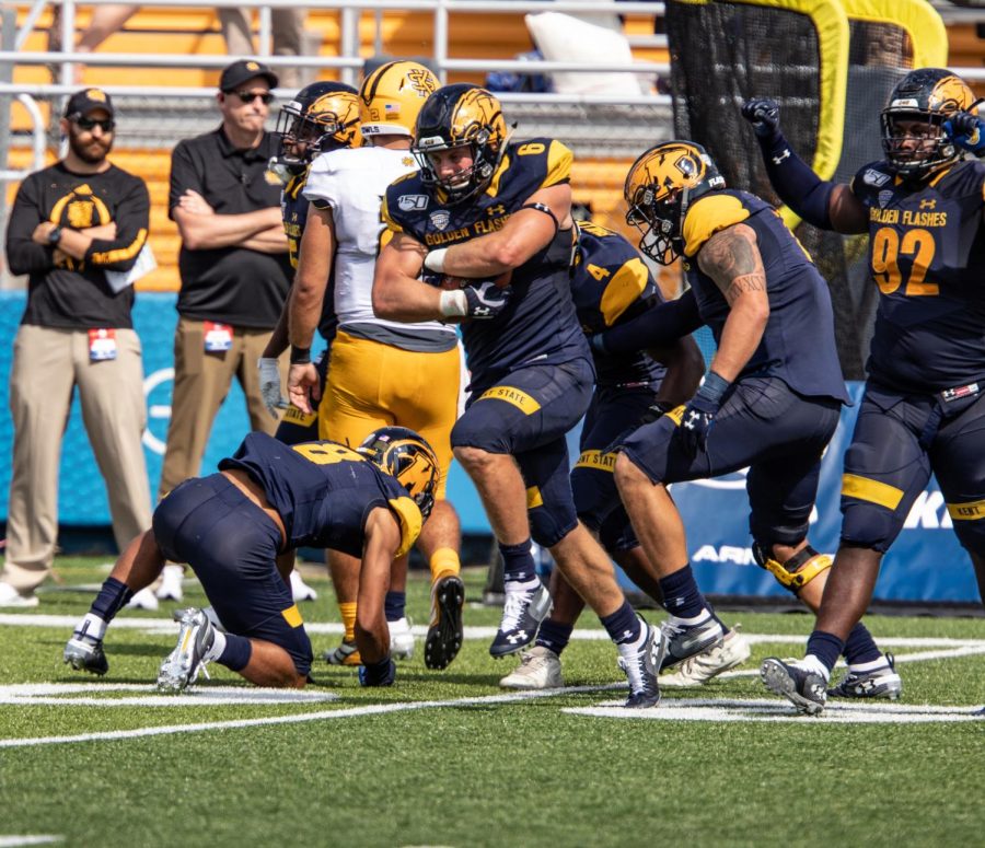 Graduate linebacker Matt Bahr clutches the ball after recovering a fumble in overtime during Kent State's first home game against Kennesaw State University on Saturday, September 7, 2019.