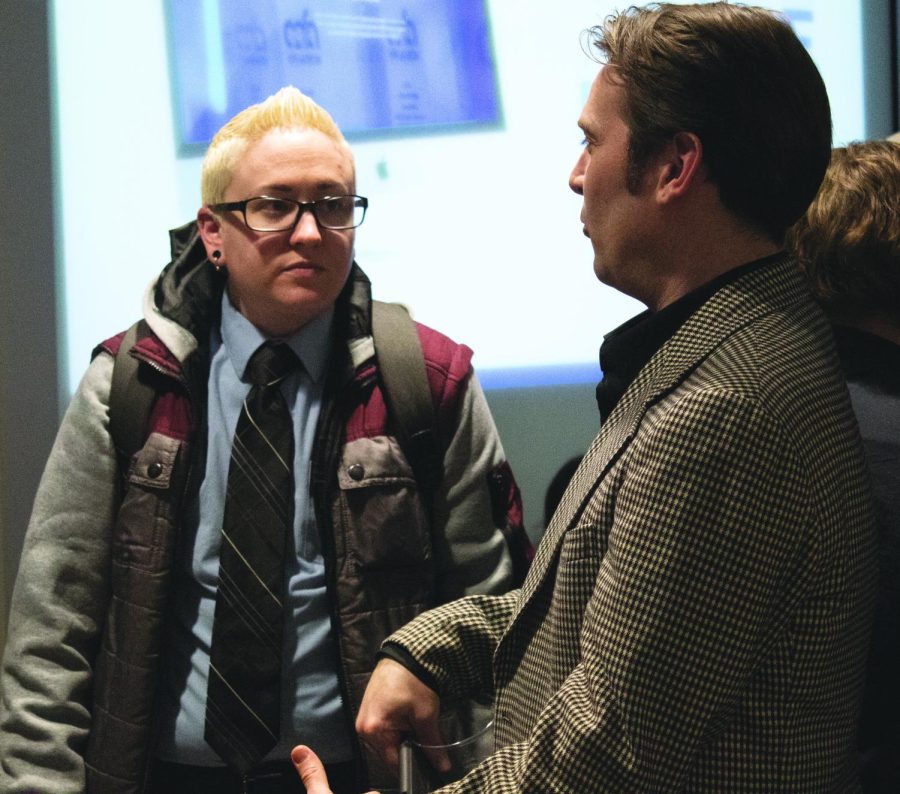 College of Communication and Information (CCR) Diversity Director AJ Leu speaks to visitors at the Christopher Darling Memorial Gallery Show. The gallery is located in Taylor Hall, while the mental health discussion followed after in Cartwright Hall.