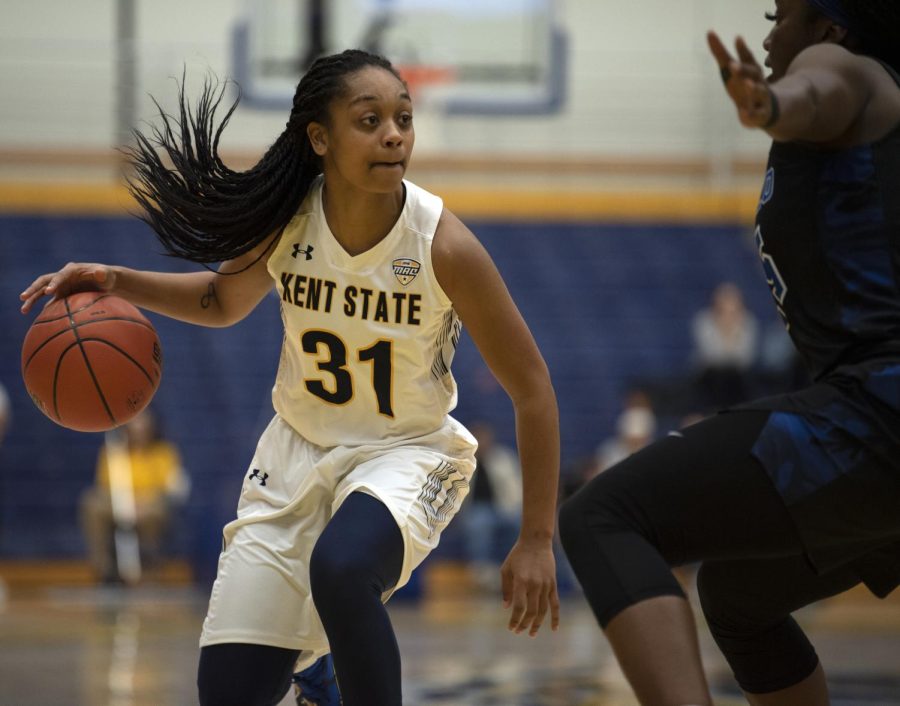 Redshirt senior Megan Carter (31) is guarded by an opposing team member during first half action on Sat. Jan. 25, 2020. Kent State lost 57-44 against the University at Buffalo.