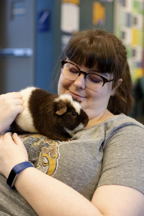 Senior advertising major Emmaline Mae Stine cuddles with her service animal Oliver. Oliver is her service animal of two years.