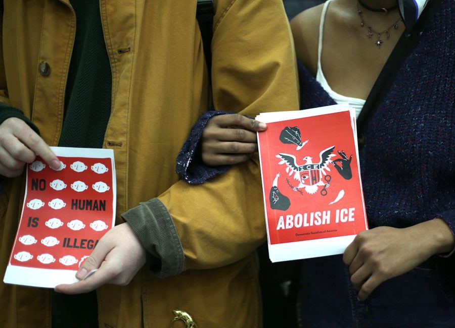 Two student protesters in front of the table of Homeland Security at Kent State’s 2020 Career Fair on Feb. 20, 2020. The students held fliers and stood peacefully in front of an abandoned table. 