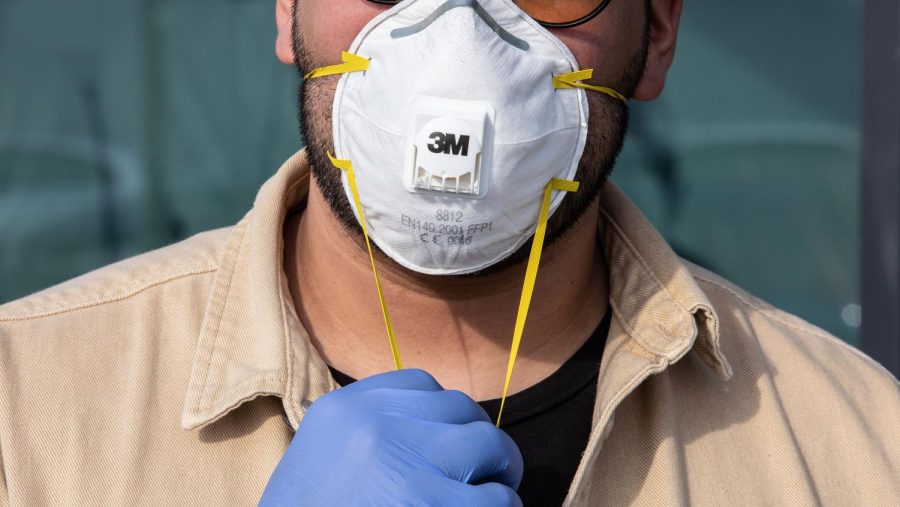 CASALPUSTERLENGO, ITALY - FEBRUARY 23: A man wearinig a respiratory mask and gloves is pictured on February 23, 2020 in Casalpusterlengo, south-west Milan, Italy. Casalpusterlengo is one of the ten small towns placed under lockdown earlier this morning as a second death from coronavirus sparked fears throughout the Lombardy region. (Photo by Emanuele Cremaschi/Getty Images)