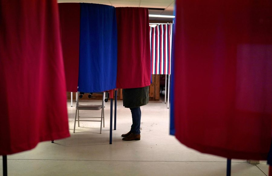 A voter marks her ballot in the state's presidential primary election in Milton, New Hampshire, U.S., February 11, 2020. REUTERS/Rick Wilking