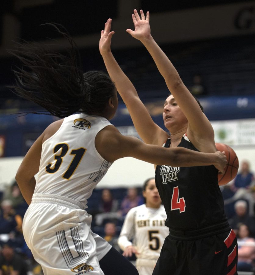 Redshirt Senior Megan Carter (31) passes ball around opponent to Sophomore Mariah Modkins (5) during first quarter on Wed. Feb. 5, 2020. Kent State University won 61-47 against Bowling Green State University.