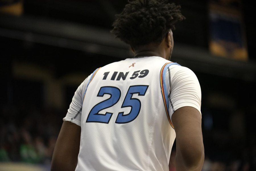 Senior Philip Whittington (25) wears autism awareness jersey designed by the Kent State University Fashion School during game against Ohio University on Sat. Feb. 15, 2020. Under Armour reached out to Kent State’s top fashion students to design the jerseys.