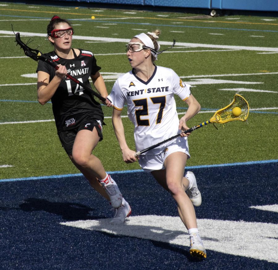 Sophomore midfielder Abby Jones [27] cradles the ball during the women’s lacrosse game on Mar. 8, 2020. Kent State University women’s lacrosse team lost to University of Cincinnati 25-8. 