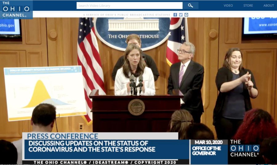 Dr. Amy Acton, Ohio Department of Health Director, center, discusses the state's response to the coronavirus outbreak, as Gov. Mike DeWine, right, studies an update on the cases on Tuesday, March 10, 2020, in Columbus, Ohio. Acton said DeWine was "leaning in" and being aggressive in taking precautions against the disease. 