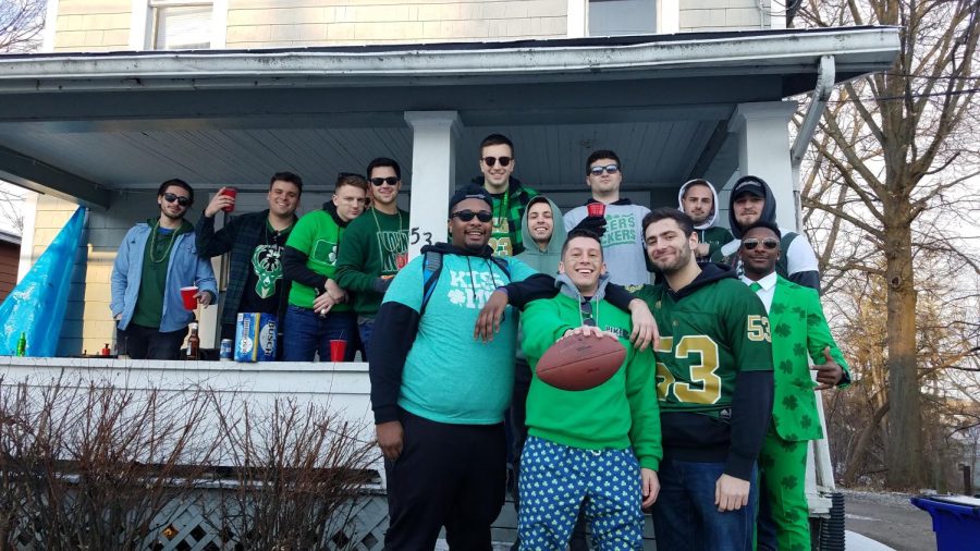 A group poses for a photo after tossing around a football in Kent, Ohio, on Summit Street, March 16, 2019. Editor's Note: Everybody in this photo is over 21. 