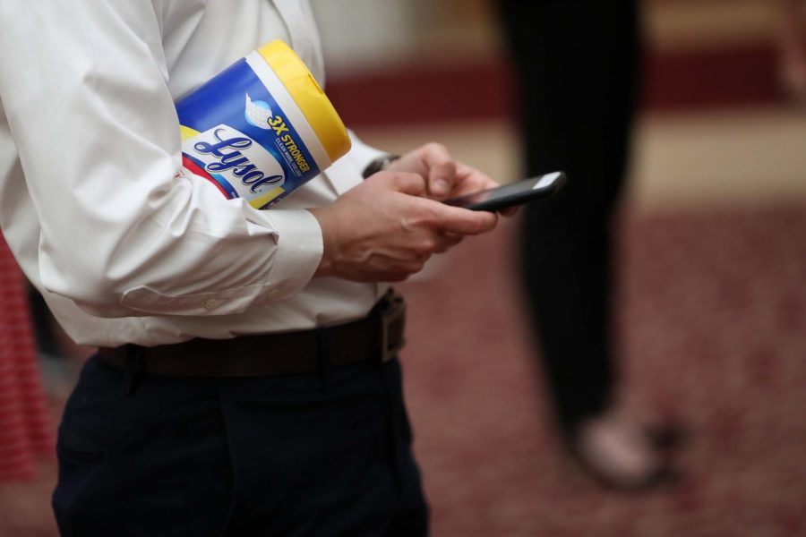 SAN FRANCISCO, CALIFORNIA - MARCH 16: An attendee holds a container of Lysol disinfecting wipes as San Francisco Mayor London Breed (R) speaks during a press conference at San Francisco City Hall on March 16, 2020 in San Francisco, California. San Francisco Mayor London Breed announced a shelter in place order for residents in San Francisco until April 7. The order will allow people to leave their homes to do essential tasks such as grocery shopping and pet walking. (Photo by Justin Sullivan/Getty Images)