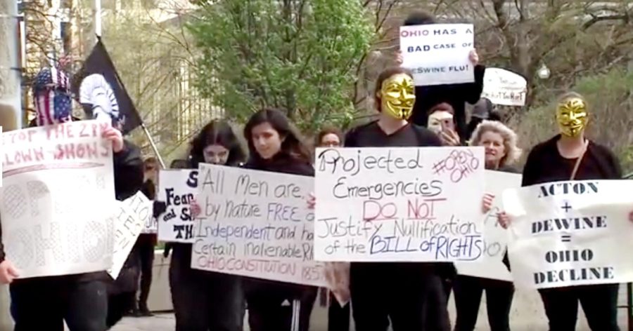 Protesters march outside the Ohio Statehouse during Governor Mike DeWine's daily press briefing April 9, 2020.