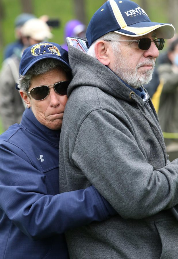 Ellen Glickman, the director of the School of Health Sciences at Kent State, hugs her husband, Harold Greenberg, who as a Kent State student was an edtior of The Kent Stater, at the conclusion of the annual ringing of the Victory Bell to remember the four students killed at Kent State on May 4, 1970, and the two students killed 10 days later at Jackson State. Despite the cancellation of events related to the May 4 50th anniversary—alternatives were offered online—the annual tradition of a candlelight march and the vigil in the Prentice Hall parking lot continued with face masks and social distancing in place.