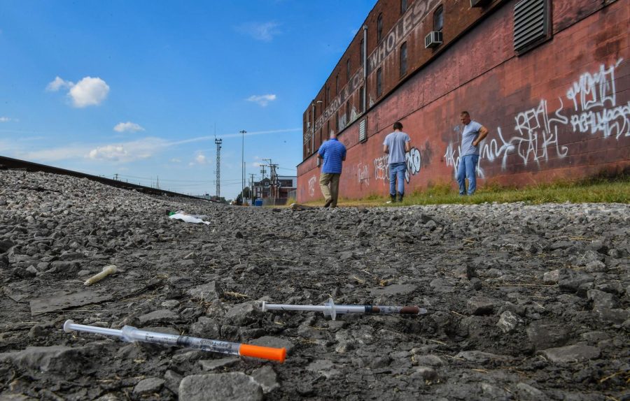 HUNTINGTON, WV - OCTOBER 2: Two partially used syringes and needles are seen as Rocky Meadows, left, former addict and founder of Lifehouse treatment and recovery center, walks with two former addicts along rail tracks where addicts use drugs on October 2, 2019 in Huntington, WV. Huntington, West Virginia is experiencing a surge in HIV cases related to intravenous drug use following a recent opioid crisis in the state. (Photo by Ricky Carioti/The Washington Post via Getty Images)