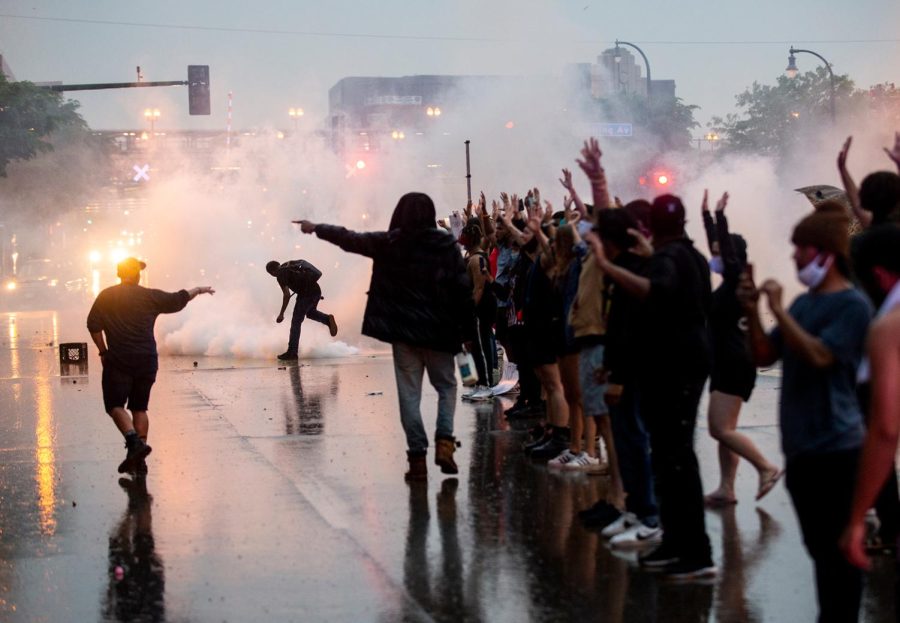 Tear gas is fired as protesters clash with police while demonstrating against the death of George Floyd outside a police precinct on May 26, 2020 in Minneapolis, Minnesota. 