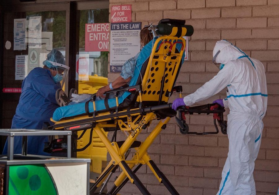 A patient is taken from an ambulance to the emergency room of a hospital in the Navajo Nation town of Tuba City.