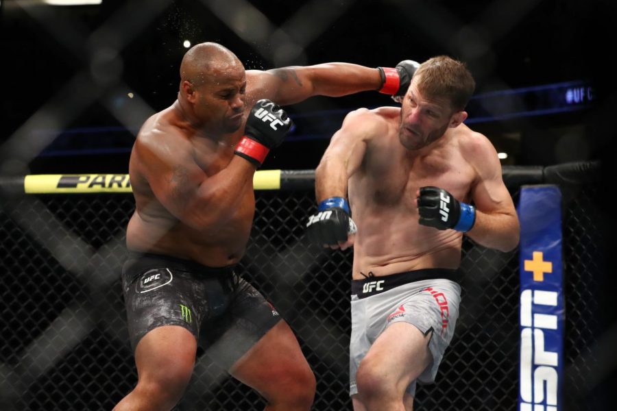 Cormier throws a punch at Miocic in the first round during their UFC heavyweight bout in 2019.