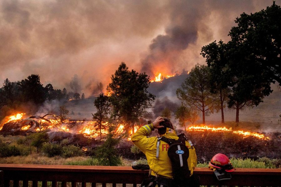 A firefighter rubs his head while watching the LNU Lightning Complex fires spread through the Berryessa Estates neighborhood of unincorporated Napa County, California, on Friday, Aug. 21.