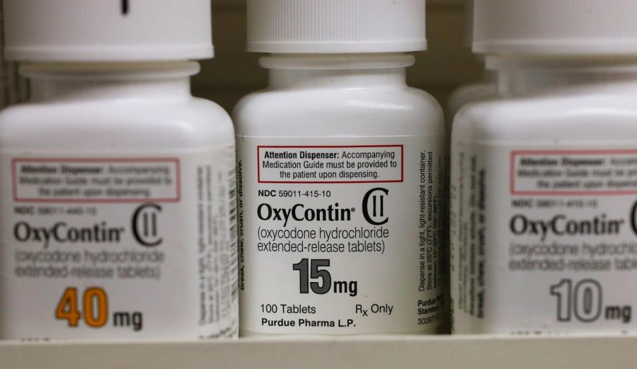 Bottles of Purdue Pharma L.P. OxyContin medication sit on a pharmacy shelf in Provo, Utah, on August 31, 2016. The drugmaker is expected to plead guilty to federal criminal charges related to the opioid crisis.