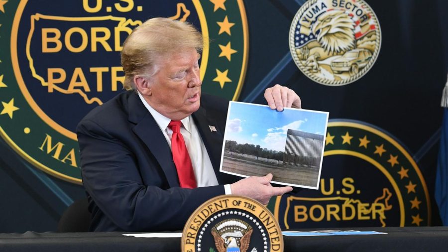 US President Donald Trump shows a photo of the border wall upon arrival at the US Border Patrol station in Yuma, Arizona, June 23, 2020.