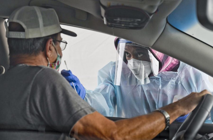 A man gets swabbed by CNA Keila Kelley. At the state run free COVID-19 testing site setup on Front Street in Reading, PA outside FirstEnergy Stadium Tuesday morning October 13, 2020. The site will be there for 5 days and was setup in response to an increase in cases in Berks County.