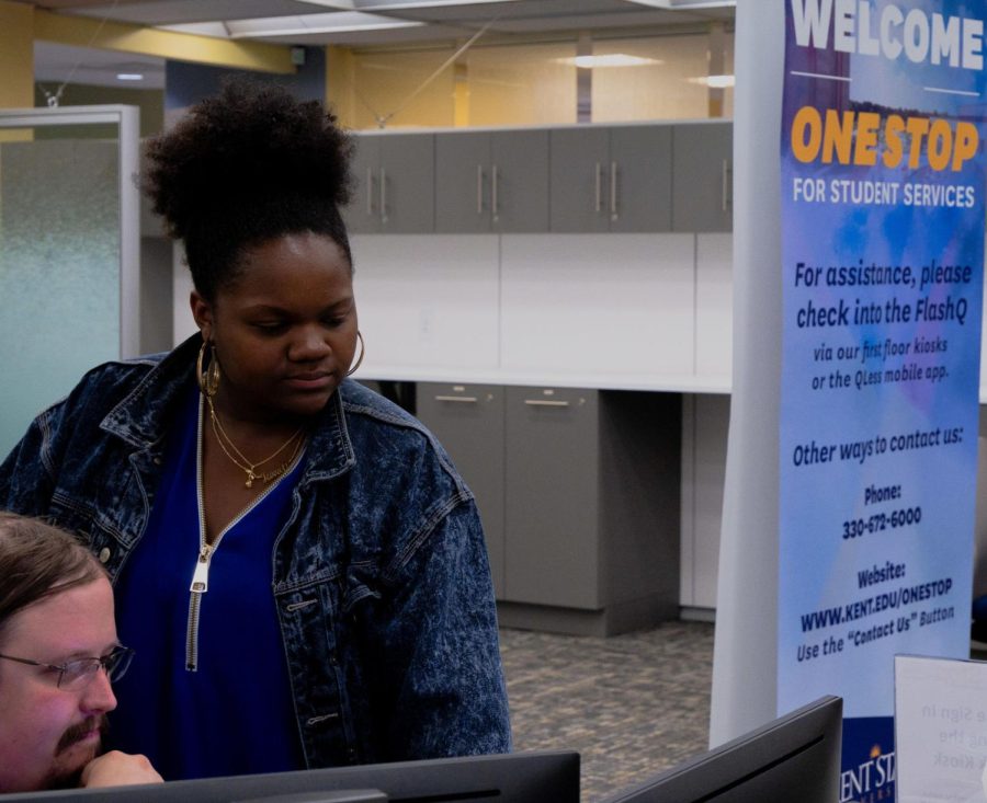 A student looks over financial aid resources in the One Stop office located in the Kent campus library. (File photo)