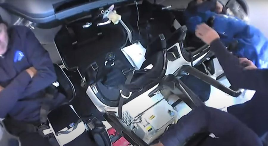 The plush Baby Yoda (top middle) can be seen in a live stream from inside SpaceX's Crew Dragon.