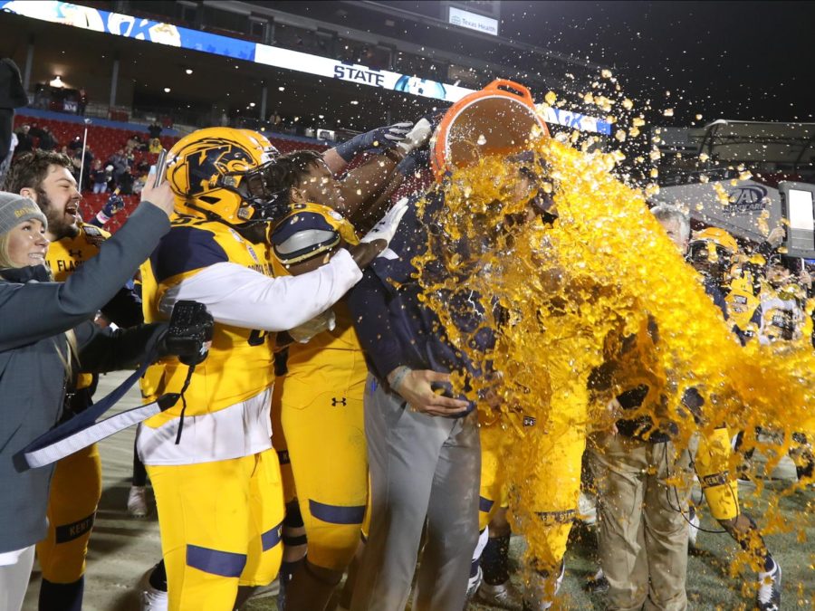 The Flashes poured orange Gatorade on coach Sean Lewis after winning the school’s first bowl game on Friday, Dec. 20, 2019. 