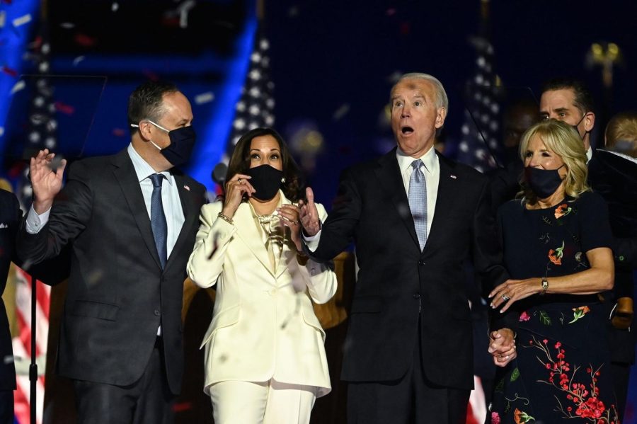 US President-elect Joe Biden and Vice President-elect Kamala Harris react as confetti falls, with Jill Biden and Douglas Emhoff, after delivering remarks in Wilmington, Delaware, on Nov. 7.