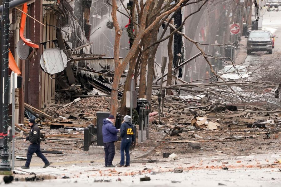 Emergency personnel work near the scene of an explosion in downtown Nashville, Tenn., Friday, Dec. 25, 2020. Buildings shook in the immediate area and beyond after a loud boom was heard early Christmas morning.(AP Photo/Mark Humphrey)