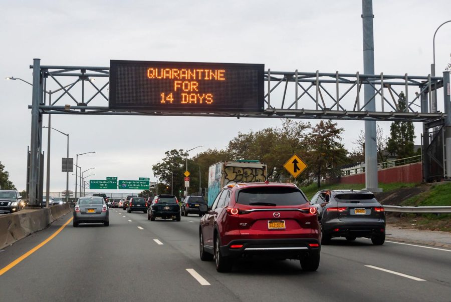 CDC will decrease coronavirus quarantine time from 14 to 7-10 days. This image shows a traffic sign reading, "quarantine for 14 days" above a road in Brooklyn on October 25, 2020 in New York City.