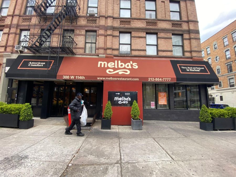 A person walks by Melba's restaurant in Harlem during the coronavirus pandemic on April 23, 2020 in New York City. COVID-19 has spread to most countries around the world, claiming over 189,000 lives with infections over 2.7 million people. 