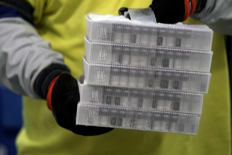 Vials in boxes containing the Pfizer-BioNTech Covid-19 vaccine are prepared to be shipped at the Pfizer Global Supply Kalamazoo manufacturing plant in Kalamazoo, Michigan on December 13, 2020. - The Pfizer-BioNTech Covid-19 vaccine was to begin leaving the company's Michigan factory on Sunday, ready to be injected into the arms of millions of the most vulnerable Americans as the global death toll topped 1.6 million.