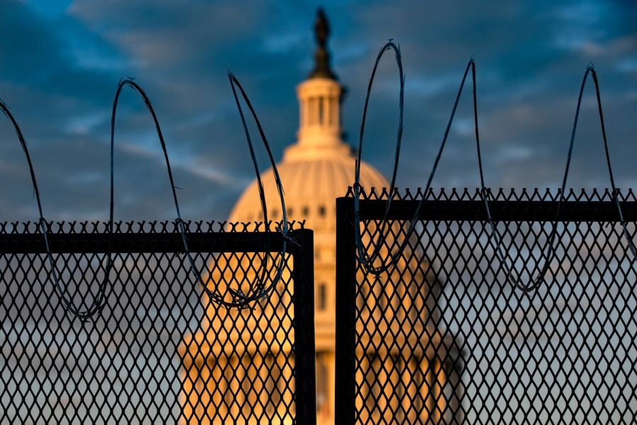 WASHINGTON, DC - JANUARY 16: The U.S. Capitol is seen behind a fence with razor wire during sunrise on January 16, 2021 in Washington, DC. After last week's riots at the U.S. Capitol Building, the FBI has warned of additional threats in the nation's capital and in all 50 states. According to reports, as many as 25,000 National Guard soldiers will be guarding the city as preparations are made for the inauguration of Joe Biden as the 46th U.S. President. (Photo by Samuel Corum/Getty Images)