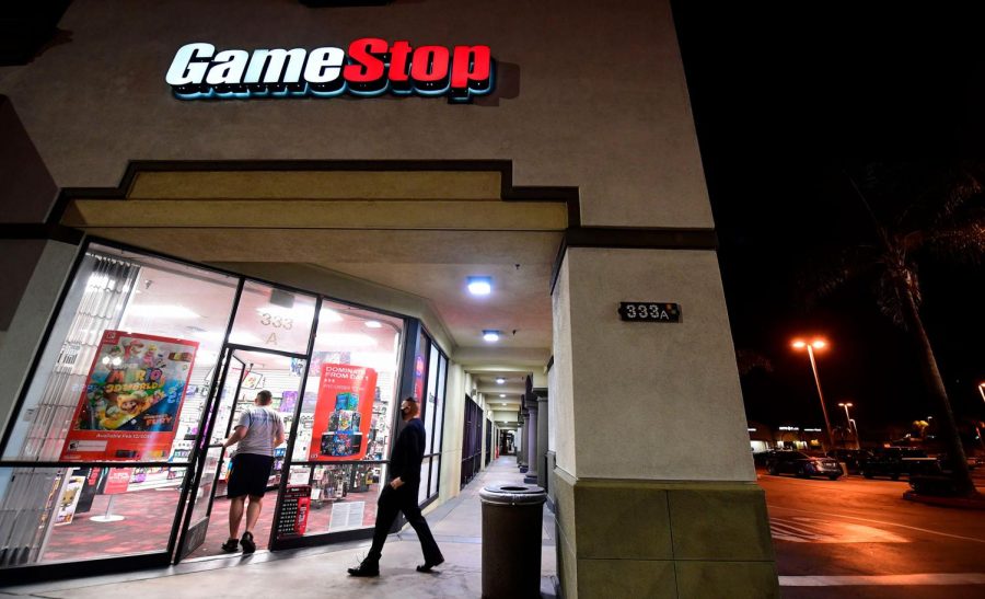 People enter a GameStop store in Alhambra, California on January 27, 2021. An epic battle is unfolding on Wall Street, with a cast of characters clashing over the fate of GameStop, a struggling chain of video game retail stores. Traders have been astounded in recent days by the surge in struggling video game retailer GameStop's share price, after a group of amateur investors banded together over the online platform Reddit to fight the Wall Street funds that had pushed its price lower. 